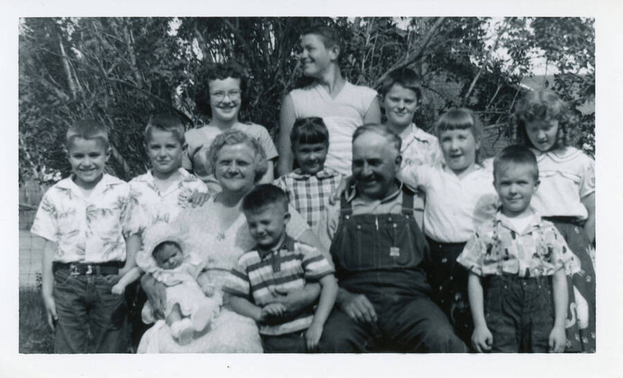 Photograph of Durell and Mary Nirk with their grandchildren. Back row: Don Strong, Doug Strong, Sharon Brandt, Allen Strong, Gary Strong. Middle Row: Mary Nirk, Cathy Nirk, Durell Nirk, Nancy Brandt, Carolyn Nirk. Front Row: Linda Strong, Jimmy Nirk, Steve Brandt.