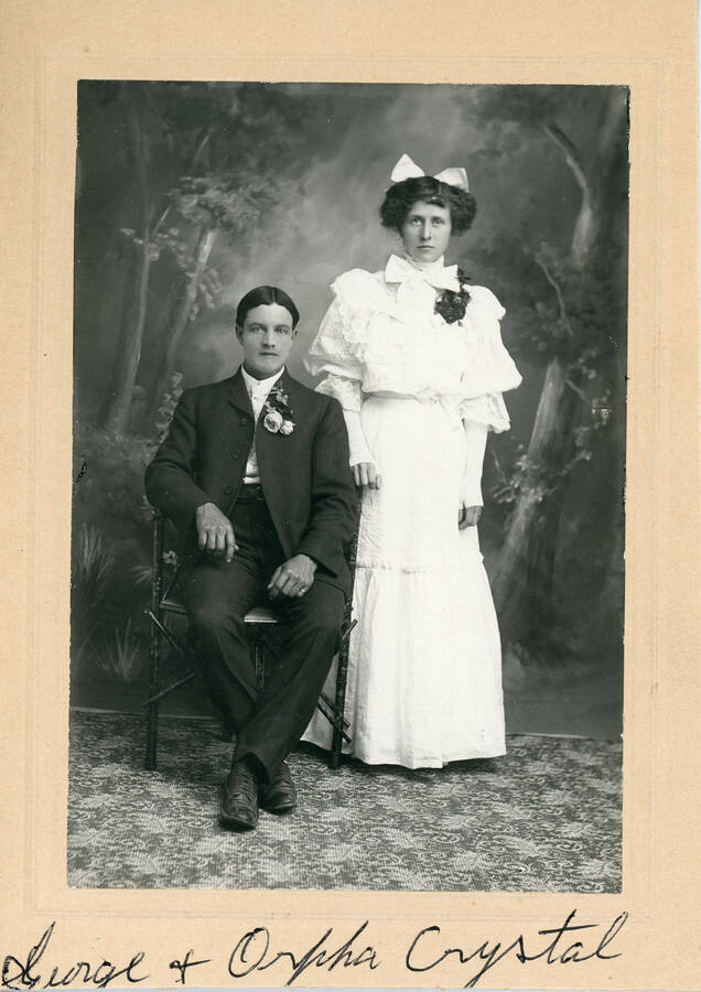 George T. and Orpha (Canfield) Chrystal pose for a formal portrait, possibly a wedding photo.