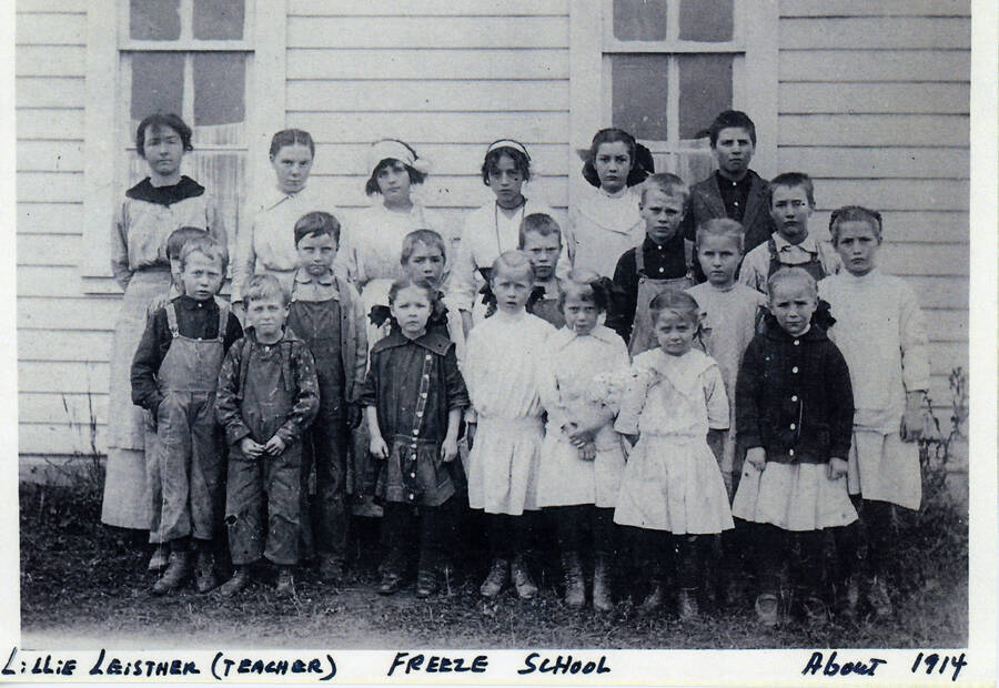 Students at the Freeze School in about 1914. Lillie Leistner, teacher, stands at the left in the back row. Student names are included but not matched to each student: Les Wolheter, Irwin Boyd, Chester Silmore, Joe McCown, Vernon Gilmore, Belva McCown, Melvin Gilmore, Mabel Gilmore, Florence Boyd, Della Woods, Jacquetta Wolheter, Lora McKown, Jonis McCown, Chuck Woods, Mary McCown.