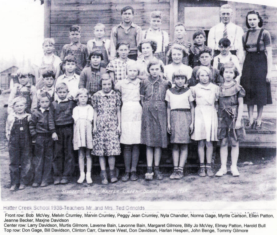 Students at the Hatter Creek School in 1938. Mr. and Mrs. Ted Grinolds were the teachers. Front row: Bob McVey, Melvin Crumley, Marvin Crumley, Peggy Jean Crumley, Nyla Chandler, Norma Gage, Myrtle Carlson, Ellen Patton, Jeanne Becker, Maxine Davidson. Middle row: Larry Davidson, Murtis Gilmore, Laverne Bain, Lavonne Bain, Margaret Gilmore, Billy Jo McVey, Elmay Patton, Harold Bull. Back row: Don Gage, Bill Davidson, Clinton Carr, Clarence West, Don Davidson, Harlan Hespen, John Benge, Tommy Gilmore, Mr. and Mrs. Grinolds.