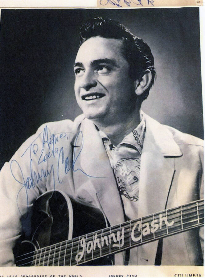 A Johnny Cash poster with a message addressed to "Agnes," signed by Johnny Cash.