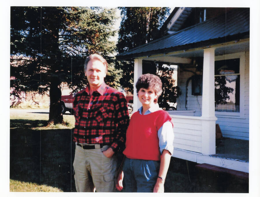 Photograph of Larry and Patty Nirk in front of their home.