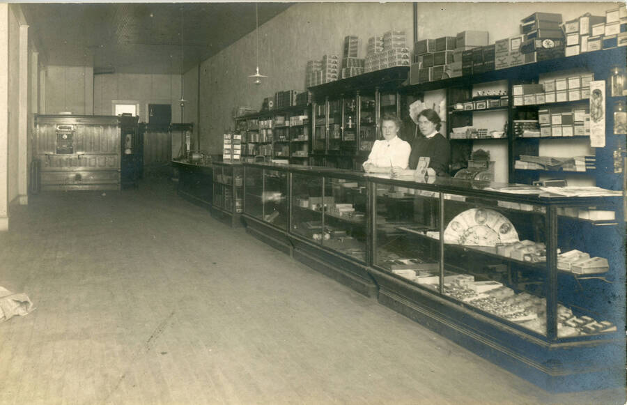 Postcard of the interior of an early Potlatch store.