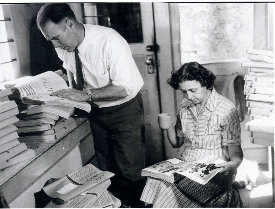 Photograph of Alec and Margaret Bull looking at Sear Roebuck catalogs that had just arrived at the Princeton Post Office.