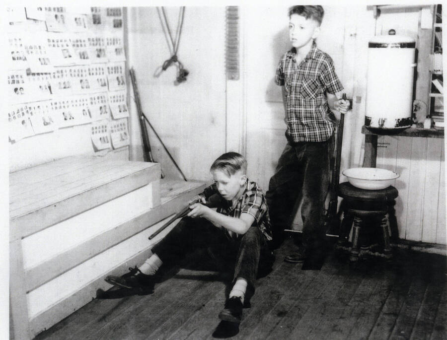 Photograph of Bill and Andy Bull having target practice in the Princeton Post Office after hours.