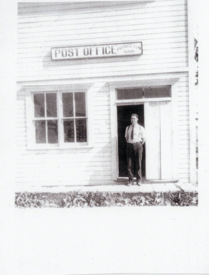 Photograph of Postmaster Alec Bull in front of the Princeton Post Office.