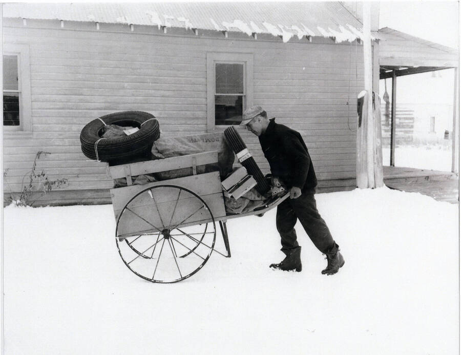 Photograph of Alec Bull pushing mail cart to the Princeton Depot to meet the Potlatcher.