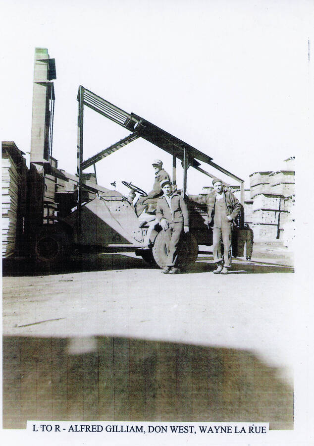 Photograph of Alfred Gilliam, Don West, and Wayne LaRue with lift truck at the Potlatch Mill.