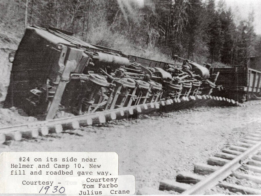 View of a No. 24 locomotive on its side after the new fill and roadbed gave way. The wreck occurred near Helmer, Idaho and Camp 10.