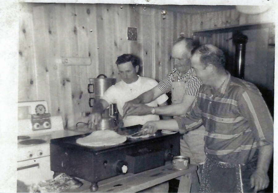 Photograph of Lawrence Curtis, Gerald Nirk and Chet Fiscus cooking pancakes at the Mountain Home Grange.