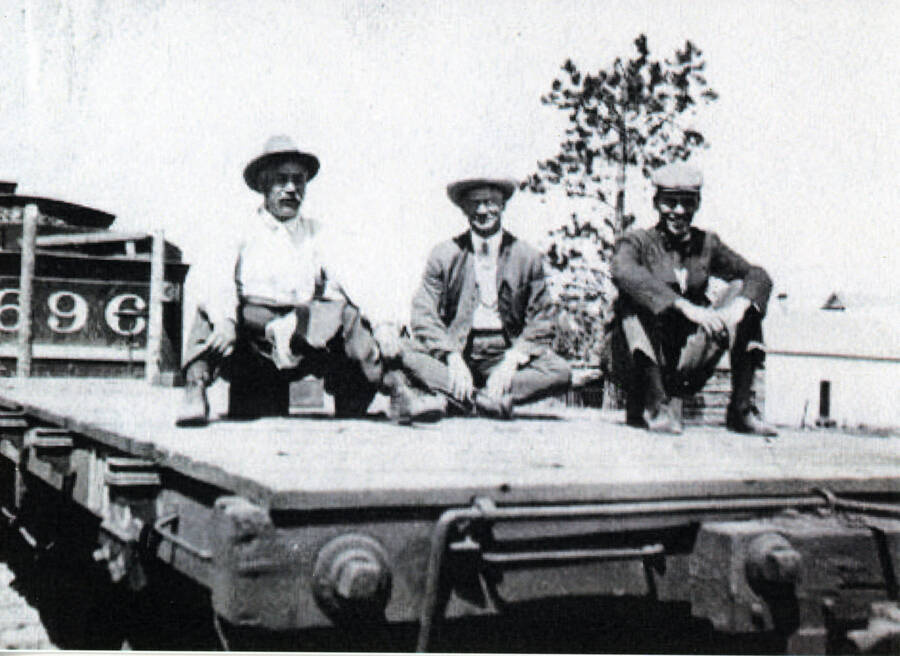 Photograph of William Deary, F.S. Bell and Laird Bell on a WI&M flatcar.