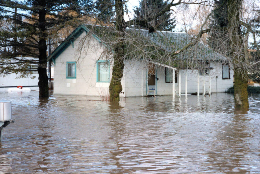 Photograph of a home underwater from a flood on the Palouse River.
