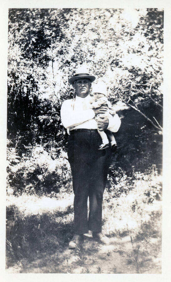 Photograph of John Bysegger holding John Jr.