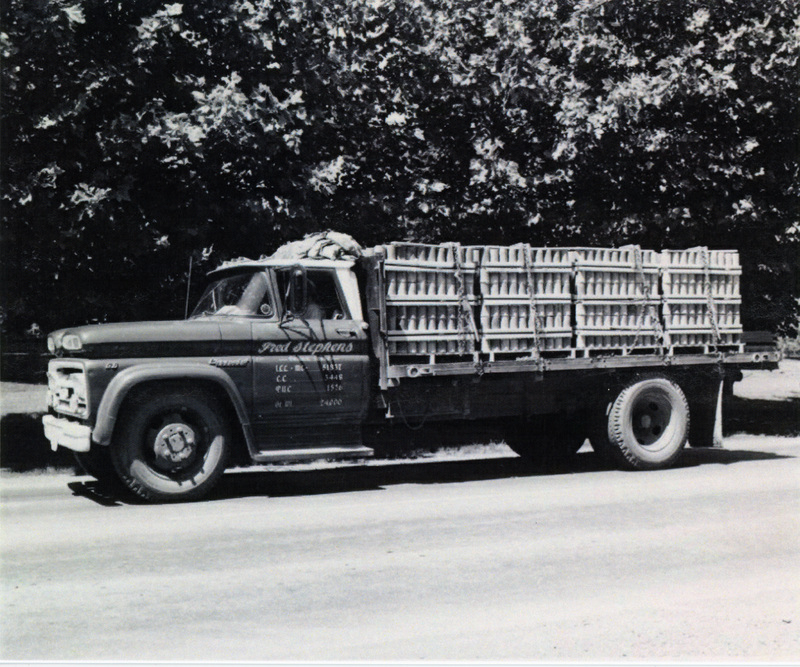 Photograph of Fred Stevens with his truck loaded with Pres-to-logs.