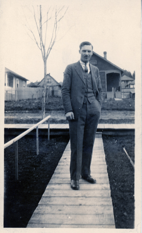 Photograph of George Alexander standing in front of the house at 720 Spruce Street in Potlatch.