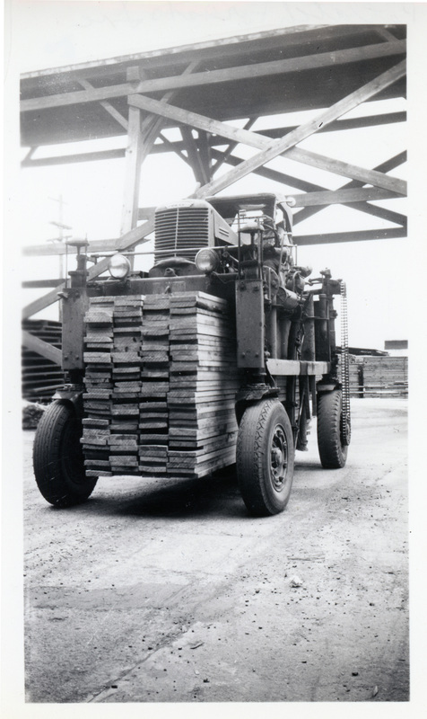 Photograph of the Straddle Bug loaded with lumber in the Potlatch Mill.