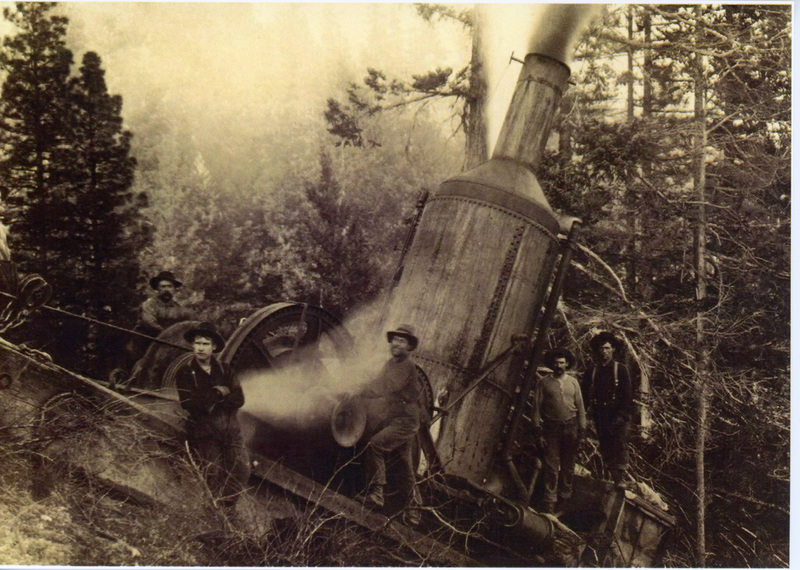 Photograph of men around a steam donkey in an unknown location.