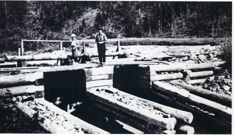 Photograph of men standing on the Rock Creek Bridge.