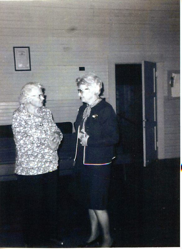 Photograph of Ida Soncarty and Norma Dobler visiting at the Mountain Home Grange.