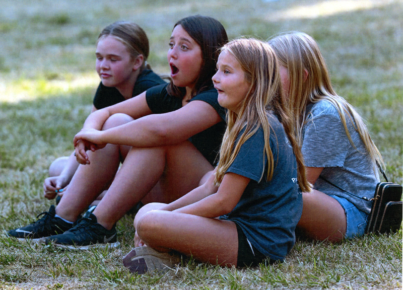 Photograph of girls watching Return to Riverside Music Festival.