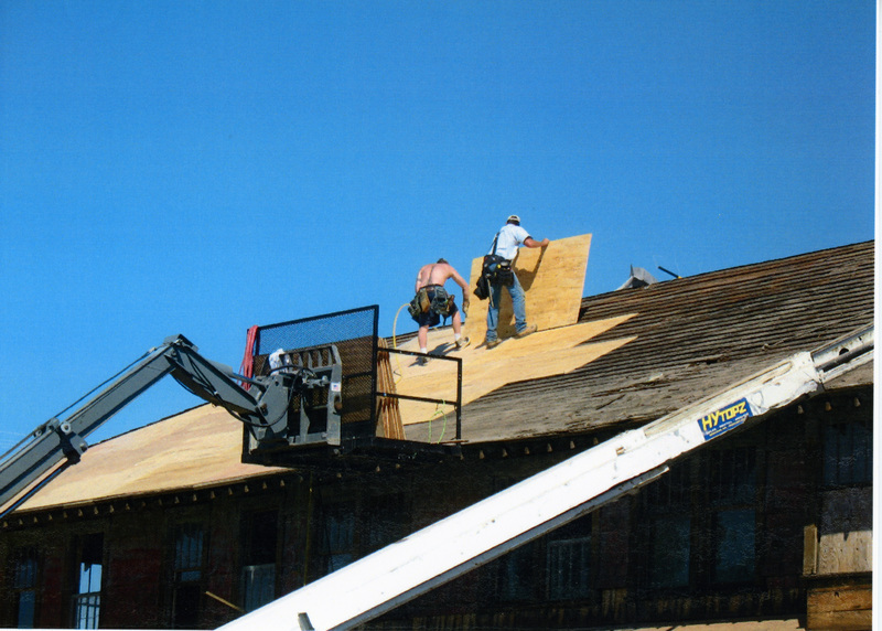 Photograph of placing plywood sheeting on the roof of the WI&M Depot.