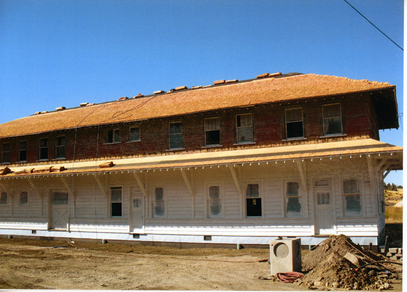 Photograph of primer being applied to the exterior of the WI&M Depot.