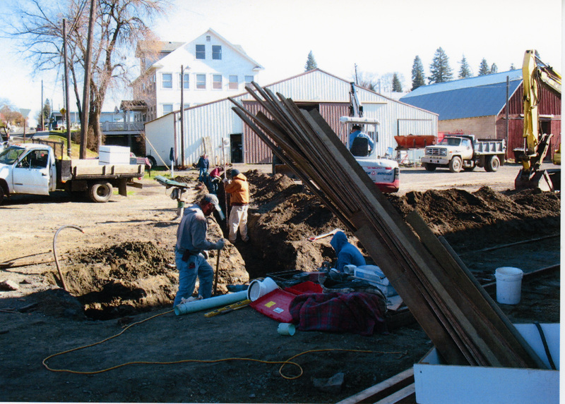Photograph of men installing drainage around the WI&M Depot.