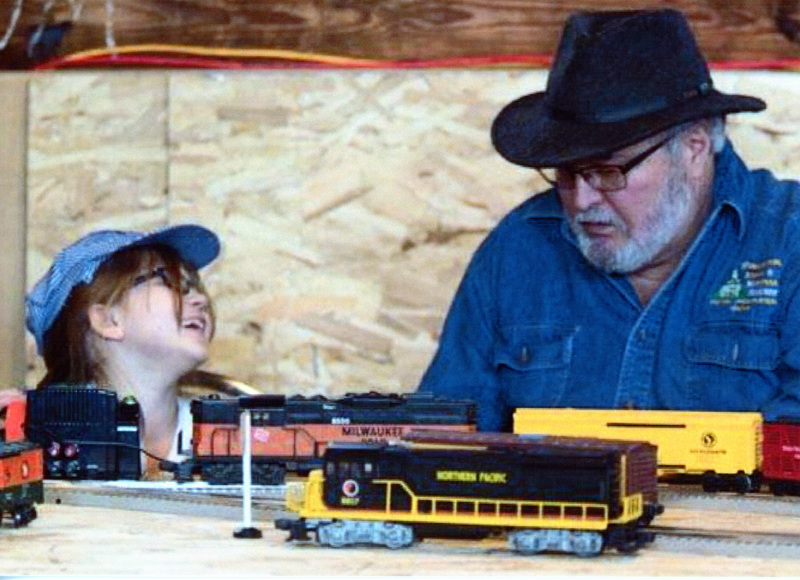 Photograph of Jim West with a child at the Engineers School at the WI&M Depot.