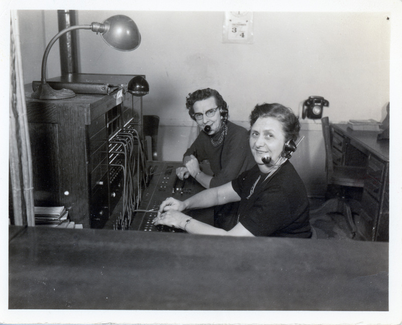 Photograph of Ruby Andres and Goldie Wolheter at the telephone switchboard in Potlatch.