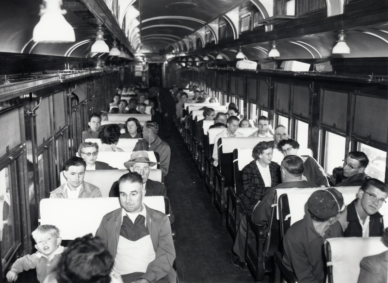 Photograph of people seated in a passenger car for the 50th Anniversary Special.