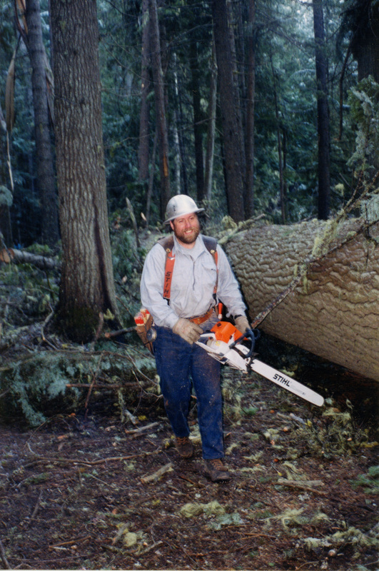 Photograph of Duane Larson with his new chainsaw.