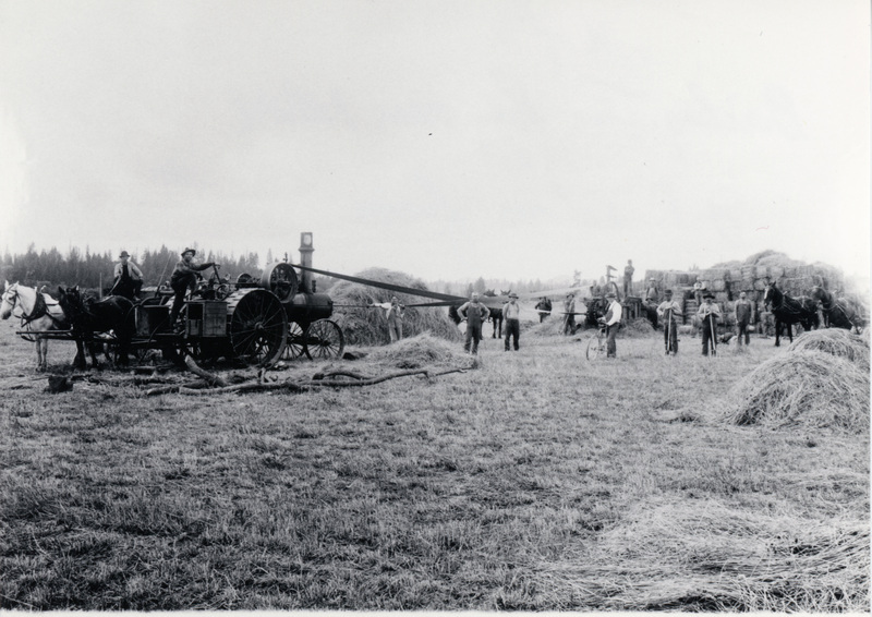 Photograph of men baling hay on the J.P. Vollmer farm.