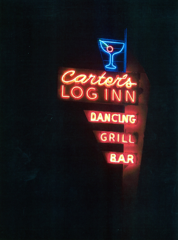 Photograph of the Carter's Log Inn neon sign lighted on its firstnight after restoration.