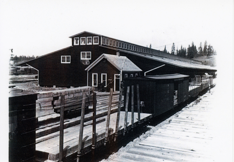 Photograph of flat cars leaving the Potlatch Mill.
