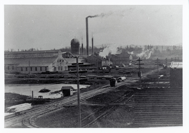 Photograph of the Potlatch mill from the northwest. Several of the Jeffrey battery locomotives are on their mainline: the hugh drying yards ar to the right.