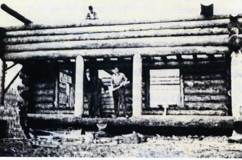Photograph of Henry Fitch on the porch of the home he built for Francis & Emily Larson.
