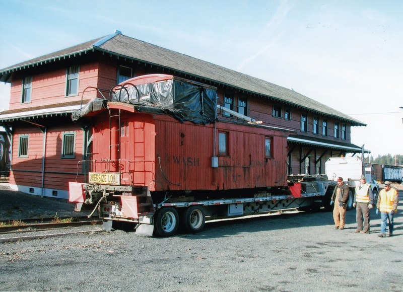 Photograph of the Caboose X-5 on a truck arriving at the WI&M Depot.