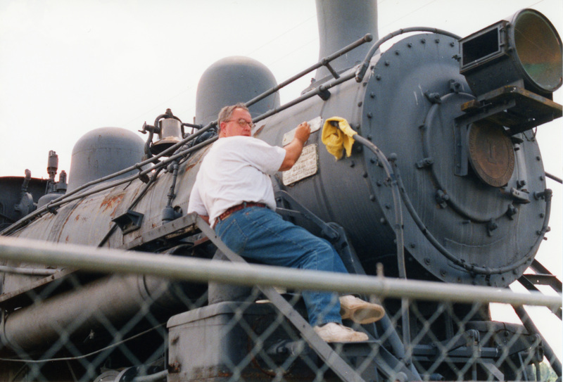 Photograph of a man working on the restoration of Locomotive #1 at Scenic 6 Park.