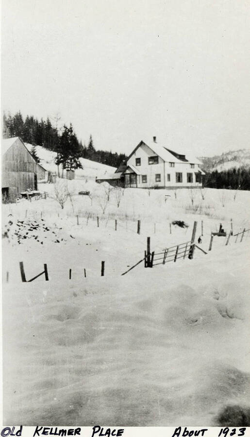 A view of the buildings and snow covered fields around the Old Kellmer Place in winter. Photograph taken about 1923.