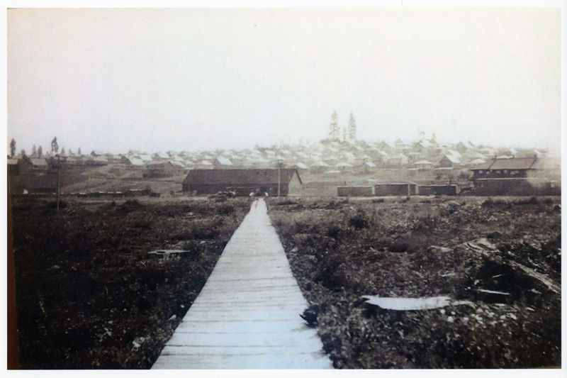 Photograph of the wooden sidewalk from the Potlatch mill toward the Potlatch townsite.