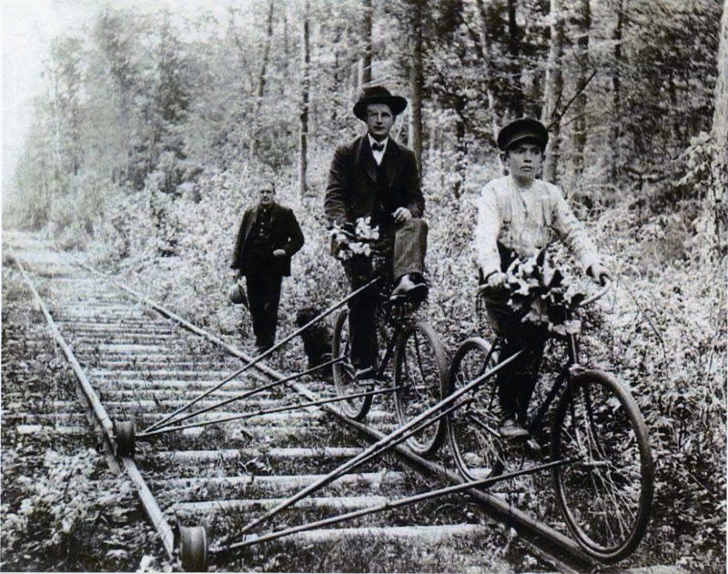 Photograph of people riding rail bikes.