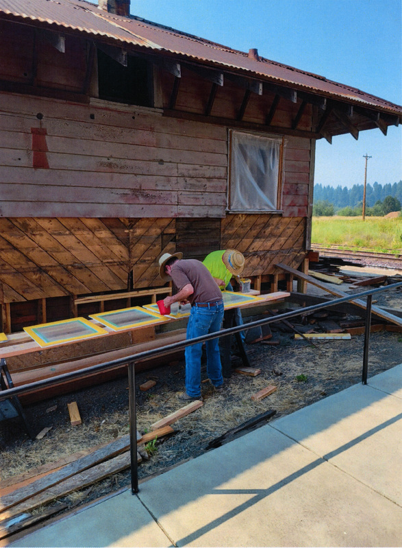 Photograph of Roger Farrell and Hal Vandevord painting window trim for the Caboose X-5 at the WI&M Depot in Potlatch.