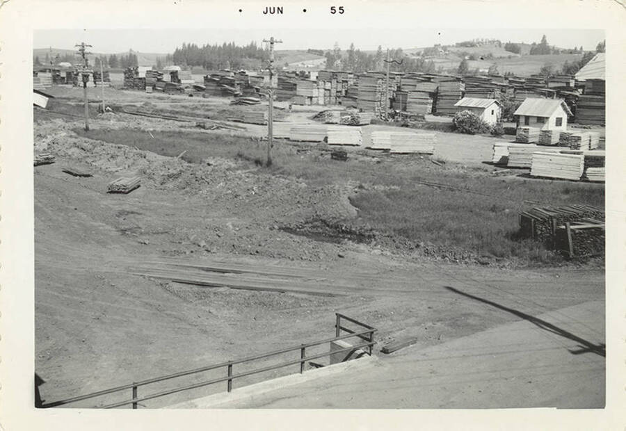 A photograph of the lumber yard from a distance.