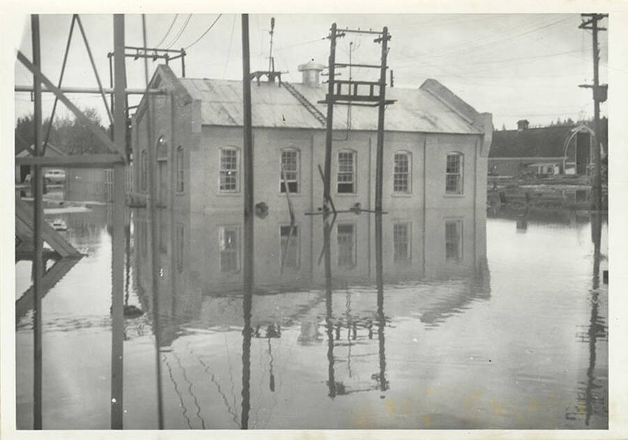A photograph of the outside of a building used at the sawmill during a flood.