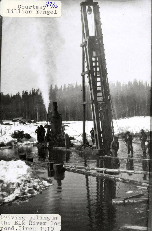 A photograph of the crew driving piling in the Elk River log pond.