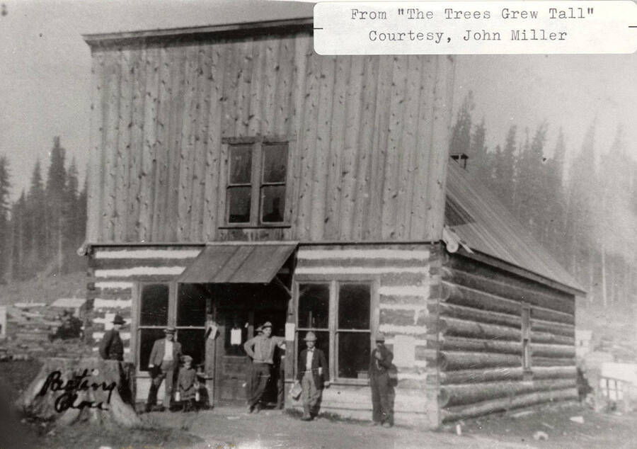 A photograph of residents and a trading post from 'The Trees Grew Tall' courtesy of John Miller.