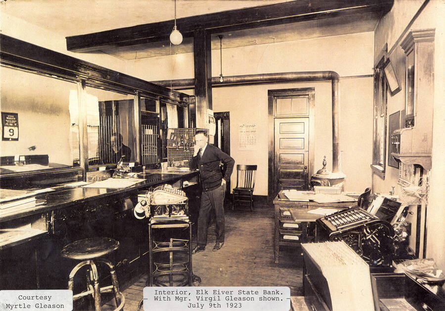 A photograph of the interior of Elk River's State Bank with Manager Virgil Gleason.
