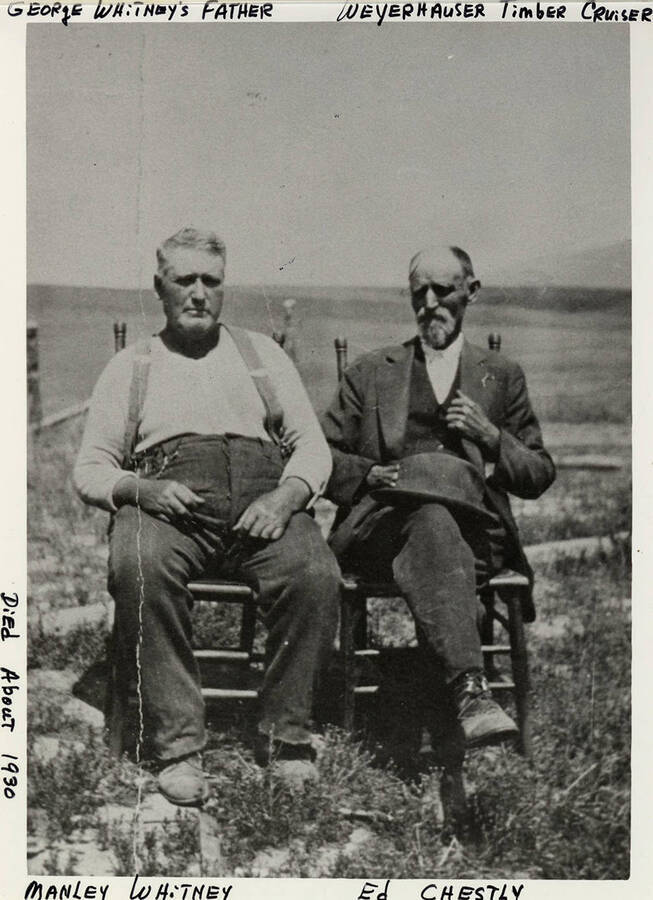 Manley Whitney and Ed Chestly sit together in chairs.  Manley Whitney was George Whitney's Father. He died around 1930.