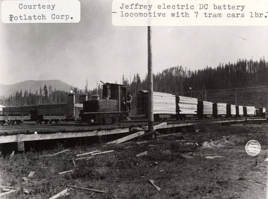A photograph of a Jeffery electric DC battery locomotive with 7 tram cars.