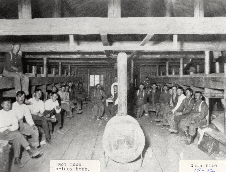 A group of men sitting in a cabin at one of the PLC camps.